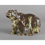 A Royal Copenhagen model of a prowling bear, by Kund Kyhn in an all over mottled brown and green