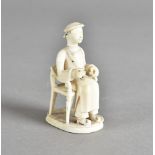 A 19th century Chinese ivory figure of a seated gentleman, wearing long robes and beads, 5.5 cm high