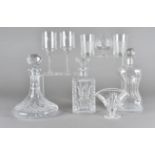 A collection of cut glass decanters, four brandy balloons, six wine glasses with engraved bowls,