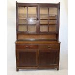 A Staines of Westminster Kitchen Equipment Suppliers Ltd Arts and Crafts Oak glazed dresser, with