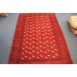 A large Turkoman woollen carpet, all over central gull pattern surrounded by a multiple decorative