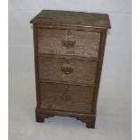 A Victorian oak chest, fitted with three short graduated drawers, 58 cm wide x 40 cm deep x 98 cm