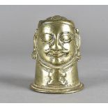 An African figural brass bell, possibly Benin, the mask with oval eyes, moustache and wide mouth