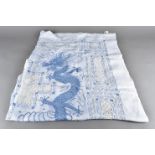 An early 20th century cotton and Peking knot embroidered table cloth, depicting the blue dragons and