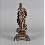 An Italian carved fruitwood figure of a saint, standing wearing a robe upon sheaves of wheat and