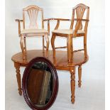 A modern pine extending dining table and two carver chairs, with central fitter leaf, together