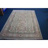 A large woollen Pakistan carpet, Zeliger style in cream green and red, 270 cm x 189cm