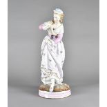 A large Volksstach porcelain figure of a women, in fashionable dress, on a circular base 46 cm high