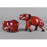Two Royal Doulton flambé elephants, modelled as a bull elephant, 23 cm wide and female and calf,
