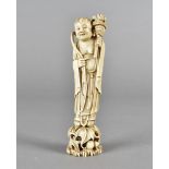 A 19th century Chinese ivory figure of a sage, standing on a lotus leaf 15 cm high and a pair of