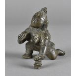 A 19th Century Indian bronze figure, of a squatting deity with ornate headdress, stamped to foot