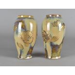 A pair of Meiji period Japanese celadon ware ovoid vases, with applied gilt decoration of song birds