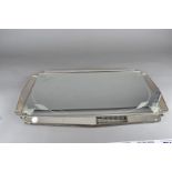 Two art deco mirrors, one with engraved floral design, 79 cm x 49 cm the other with bevelled edge 36