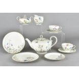 A German eight place porcelain tea service, with transfer printed floral design including teapot,