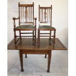 An Arts and Crafts oak extending dining table, together with five single chairs and two carvers with
