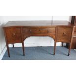 A Georgian Mahogany Sheraton style inlaid sideboard, with serpentine top, decorated with grotesques,