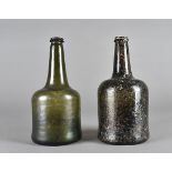 An early green glass wine bottle, the cylindrical body with tapered neck and double ringed rim, 24