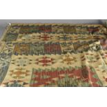 A kilim wool rug, with all over lozenge pattern, red, green, blue and white, 216 cm x 152 cm