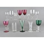 A collection of 19th Century and later drinking glasses, including a toasting glass, three cranberry