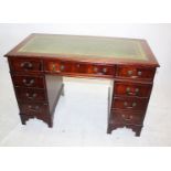 A reproduction mahogany veneers twin pedestal desk, with green leather tooled insert to top, 121