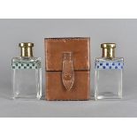 An Edwardian gentlemans travelling double cased scent bottles, the rectangular glass bottles with