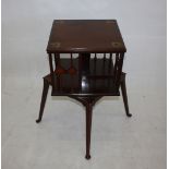 An Art Nouveau mahogany library revolving bookcase, inlaid with stylised flower heads in copper