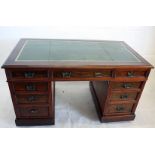 A stained beech early 20th century twin pedestal desk, with green leather and gilt top, 138 cm