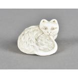 A Meiji period Japanese ivory netsuke, carved as a seated cat biting its own tail, 3.5 cm x 2.5 cm