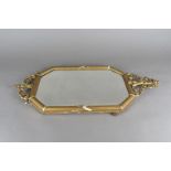 A 19th Century elongated octagonal bevelled glass and gesso framed wall mirror, 76 cm x 35 cm (af)