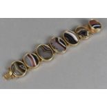 A 19th century gilt mounted oval agate bracelet, the oval banded agate panels in collet settings and