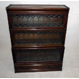 A Globe Wernicke three section bookcase, with slide over leaded glass fronts 67 cm wide x 29 cm deep