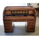 A early Victorian mahogany veneered roll top desk, with pull out desk and fitted interior, all locks
