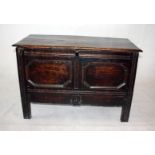A 17th century oak and elm four plank coffer and lid, with decorative frieze to front and lower