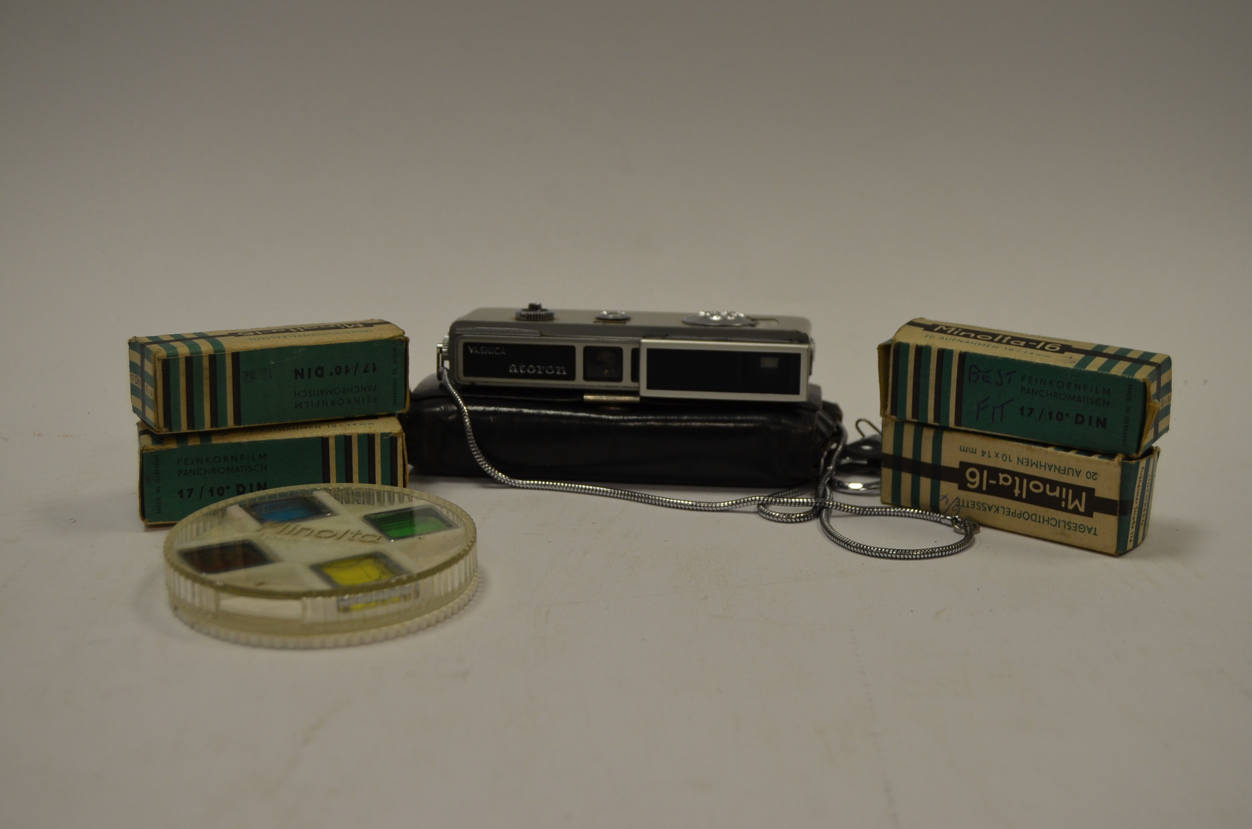 A Yashica Atoron Minature Camera, complete with flash gun, case, filters and 4 unopened Minolta 16