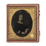 A Sixth-Plate Ambrotype Portrait of a Young Lady, tinted, in red gilt morocco-lined book-form