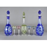 A Bohemian flashed glass liquor set, comprising four coloured long stemmed glasses and a green glass