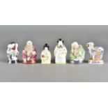 A collection of Royal Worcester Candle Snuffers, including smiling Buddha, sleeping Buddha,