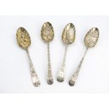 A group of four George III and later silver berry serving spoons, of differing designs, one with