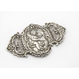 A late 19th Century continental silver belt buckle, rococo themed raised and pierced decoration with