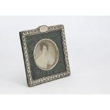 An Edwardian silver and green velvet photograph frame