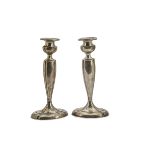 A pair of Art Deco American silver filled candlesticks, engraved initials to spreading oval bases,