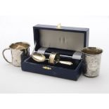 A modern cased silver teaspoon and napkin ring Christening set, together with two white metal