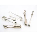 Five pairs of George III and later silver sugar tongs, each of a differing design, 6.7 ozt