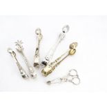 Two pairs of Victorian silver sugar tongs by HH, possibly Henry Holland, together with three further