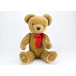 A Merrythought teddy bear, with golden mohair, jointed, velvet pads and golden label - 28in. (71cm.)