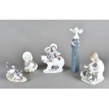 A collection of Lladro figures, including two figurines of Eskimos, another of girl with puppies,