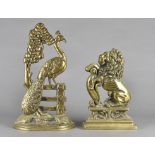 Two brass doorstops, in the form of a pheasant on fence, 43 cm high and a lion rampant, 33 cm high