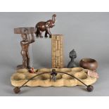 An ancient carved wooden African game, with twelve circular recesses, a balance toy, various