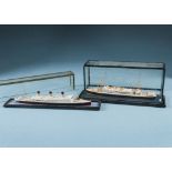 Two vintage cased Bassett-Lowke waterline models of ships, one of MV Asturias, lifeboat loose, the