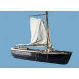 An early 20th century clinker built pond yacht, the 101cm stained wooden plank hull with